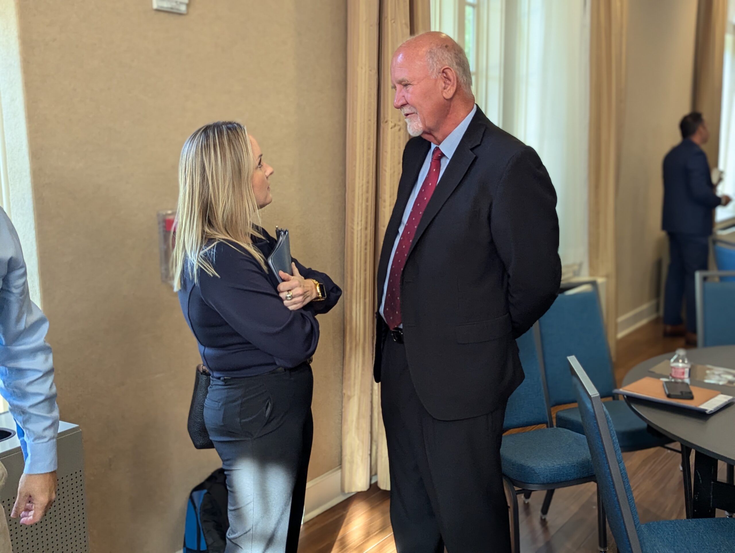 Long Beach Mayor George Bass talks to a lady at the State of Long Beach Breakfast with the Mayor