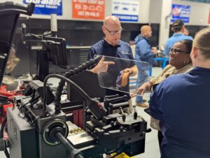 A teacher at Long Beach, MS CTE explains how a machine works